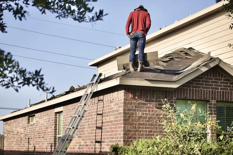 Professional roofer working on a residential roof in Frederica